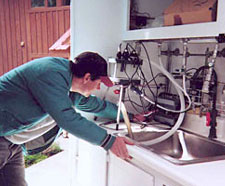 Photograph of hydrologic technician analyzing water samples in the mobile water-quality laboratory. (Photograph taken by Jim Ebbert, U.S. Geological Survey, July 2001.)